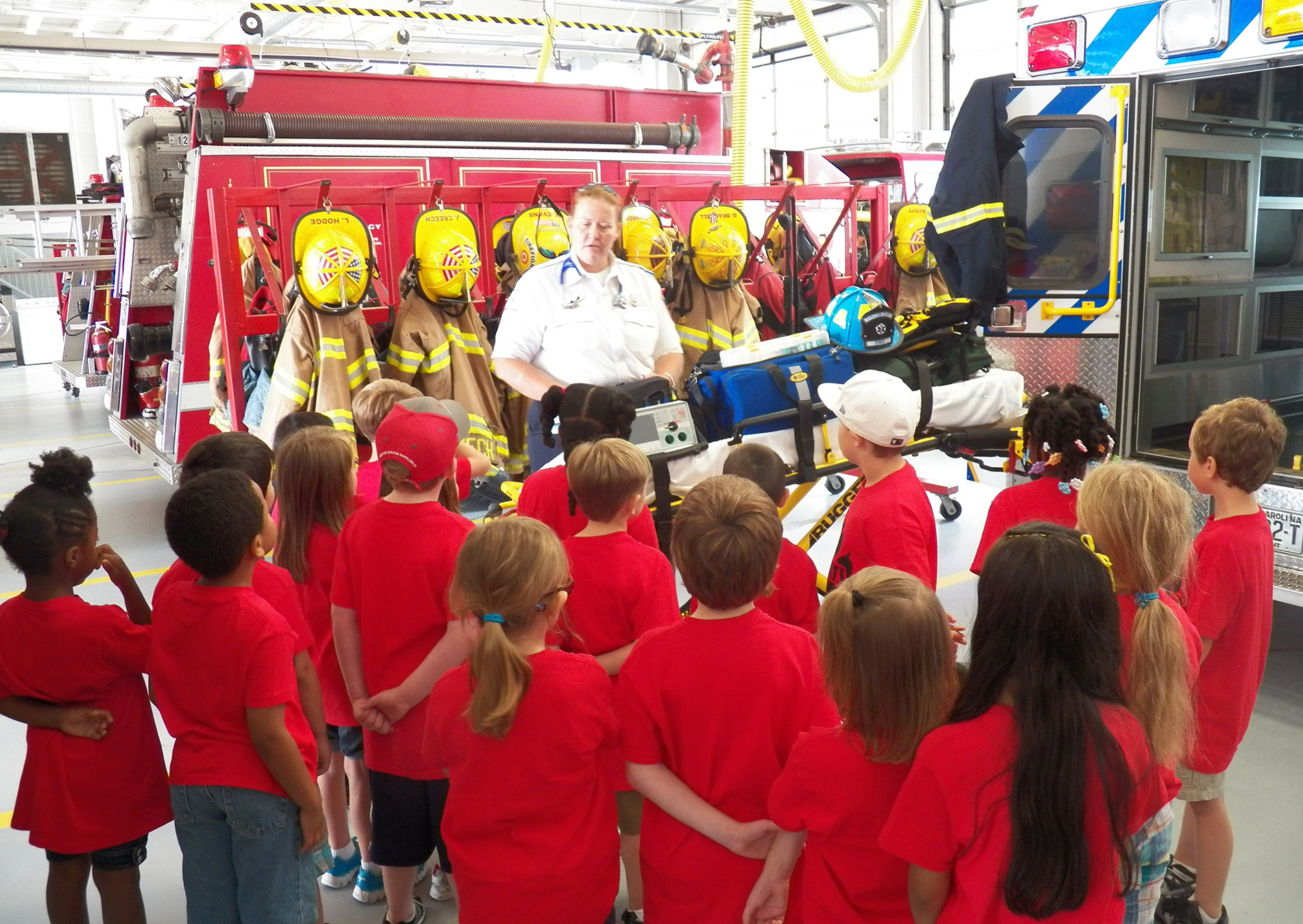 Kids visiting a station and touring the ambulances